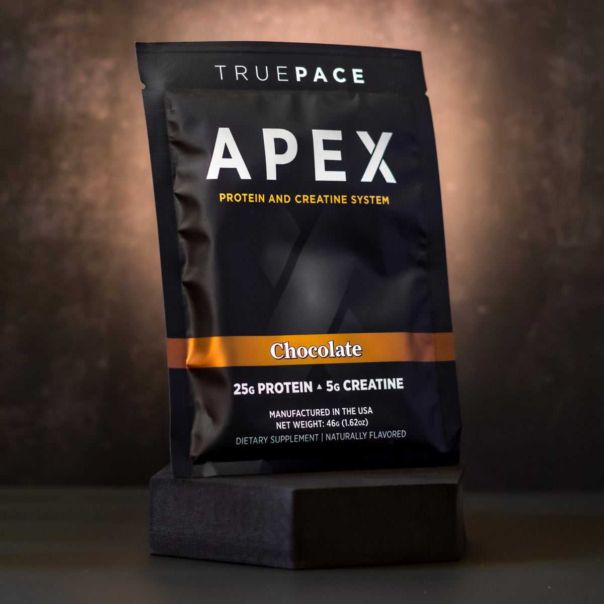 truePACE APEX Chocolate single-serve protein and creatine packet, front of pack on a dark background