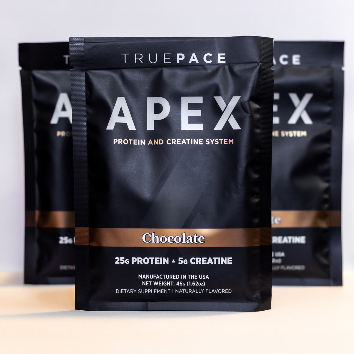 truePACE APEX Chocolate multi-pack of single-serve protein and creatine packets on a white background
